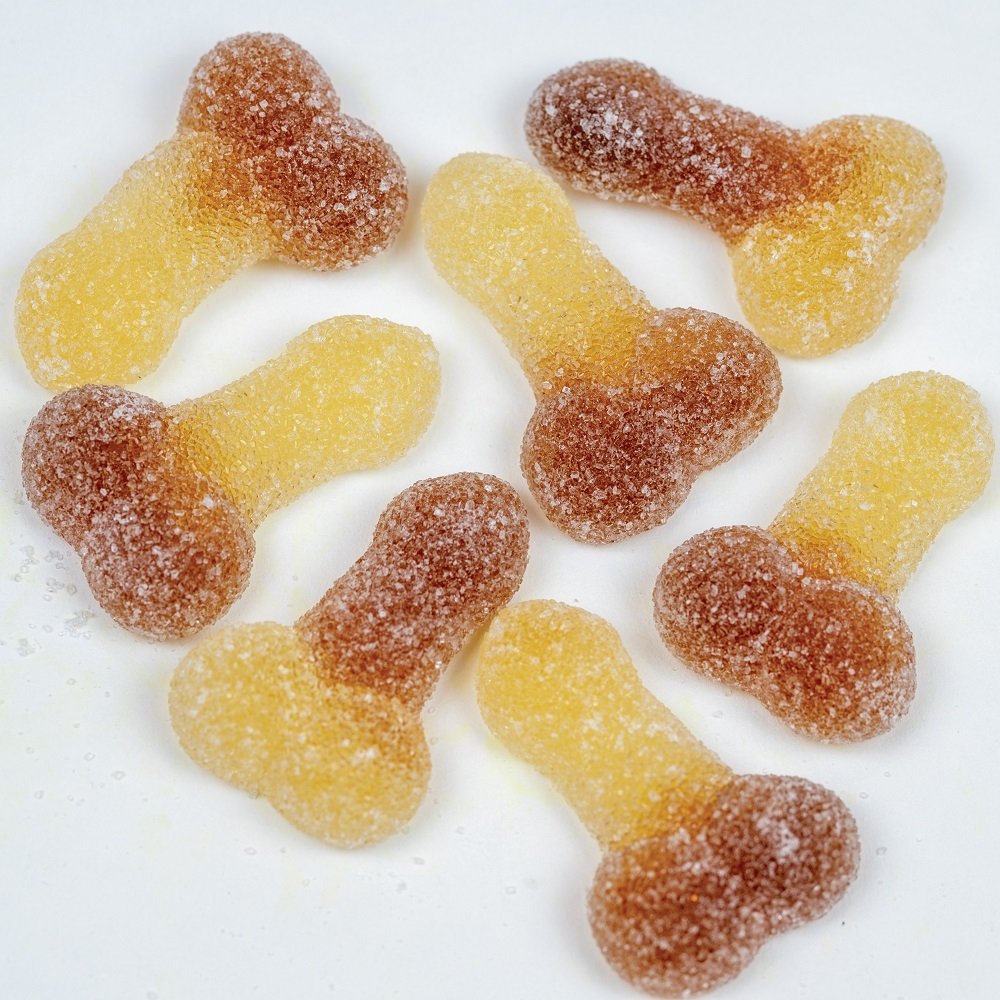 Sugared cola-flavored gummy sweets in novelty shapes on a white background
